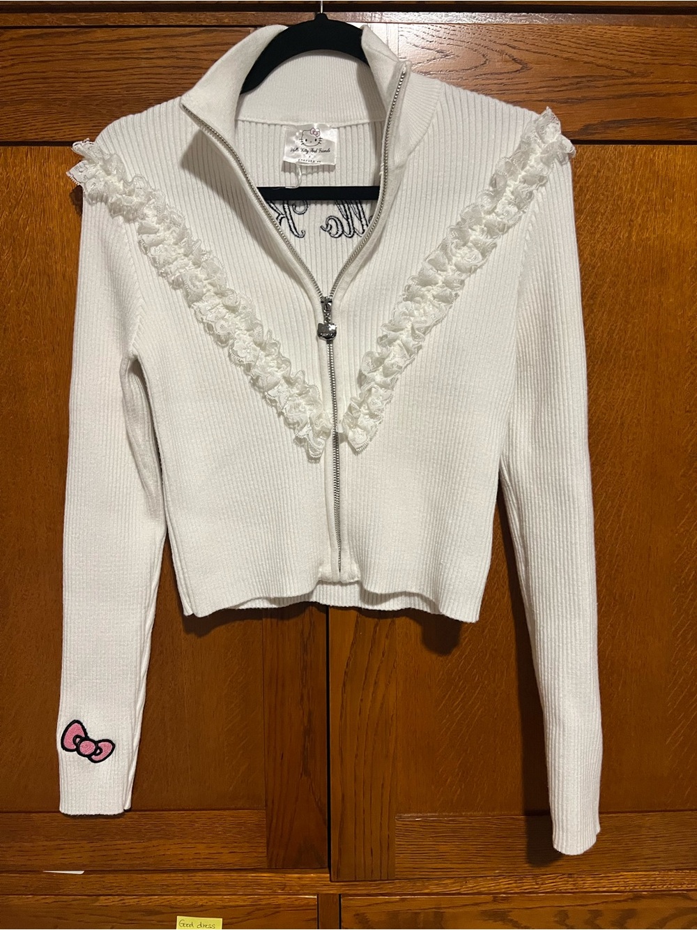 Hello Kitty Cream Zip-Up Cardigan with Ruffle V Detail and Pink Bow Patch